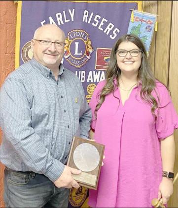 New Lions Club President DeLynn Butler presents the Lion of the Year Award to Mitch Grant.